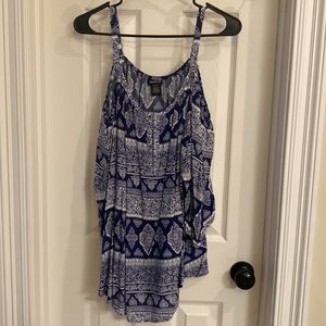 Navy blue and white with pattern. Cold shoulder, with a loose fit.